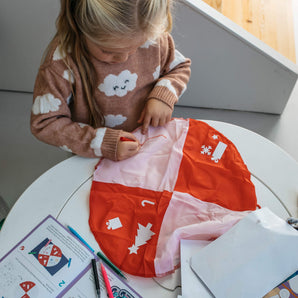 Girl decorating her Santa's Doodle Parachute Sleigh craft